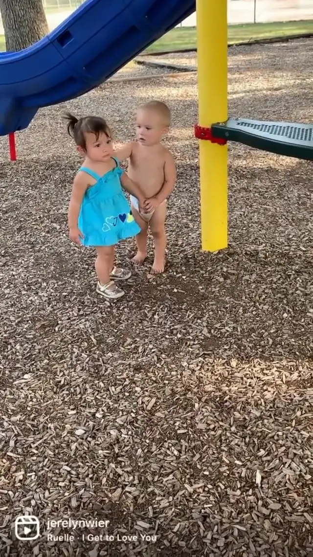 Sweet Baby Boy Holds Hands With Little Girl at the Park