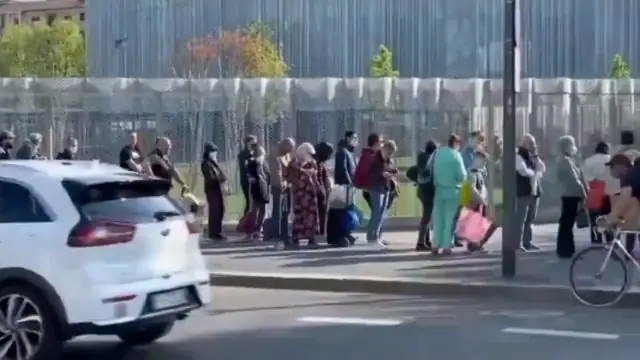 Food Shortages: Thousands of citizens lined up silently to collect a food package in Milan